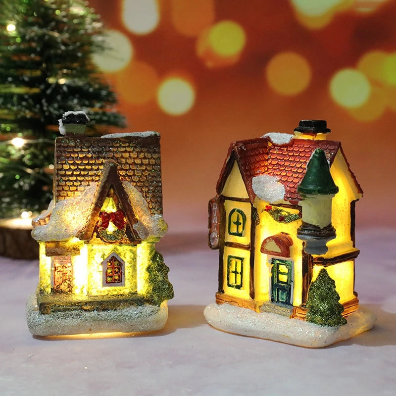 Two illuminated miniature Christmas houses with a blurred festive background.