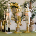 Decorative nutcrackers on a table with Christmas decorations in the background