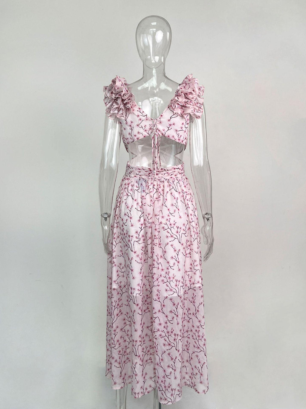 Mannequin wearing a pink floral dress on a white background