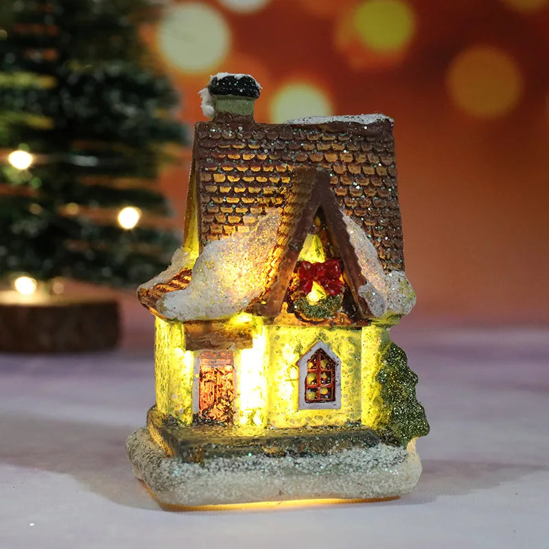 Decorative lit house with a Christmas tree in the background