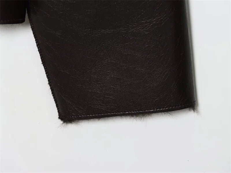 Close-up of black leather texture on a white background