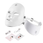White LED face and eye mask with cables and user manual on a white background