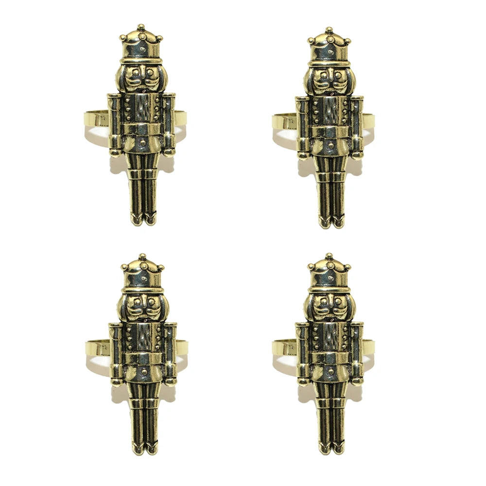 Four gold and black nutcracker-shaped rings on a white background