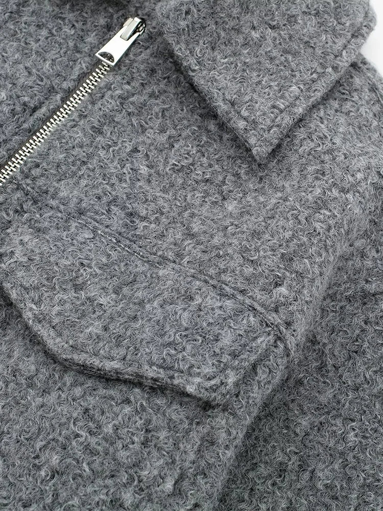 Close-up of a gray textured fabric with a zipper