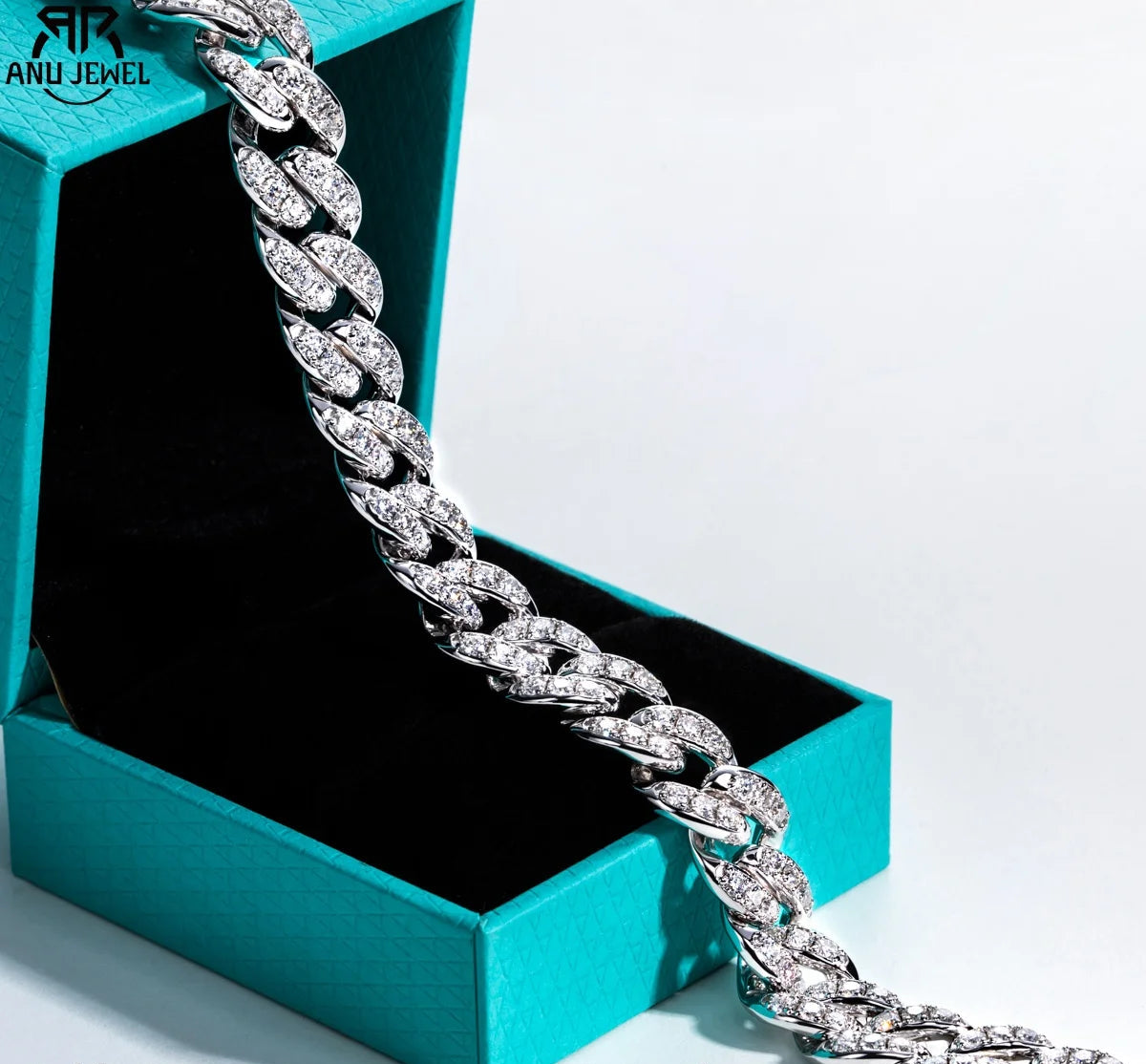 Silver chain bracelet with moissanite stones in a teal jewelry box