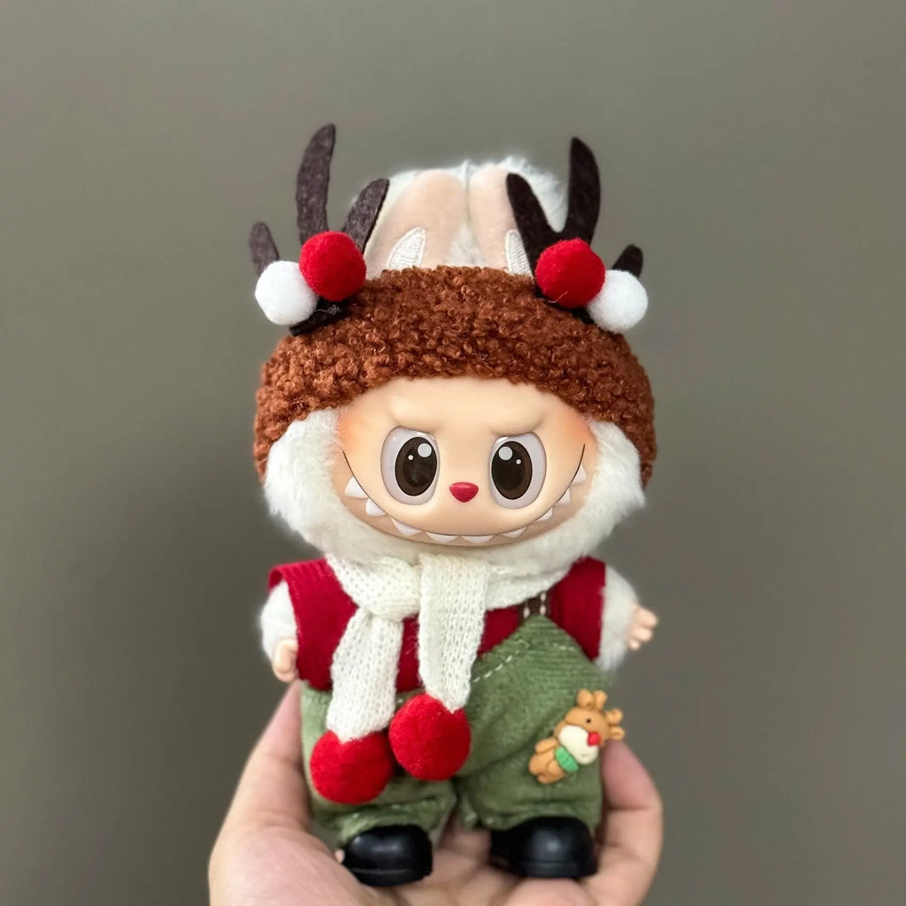 Toy figure of a character with reindeer antlers and a brown hat held against a gray background