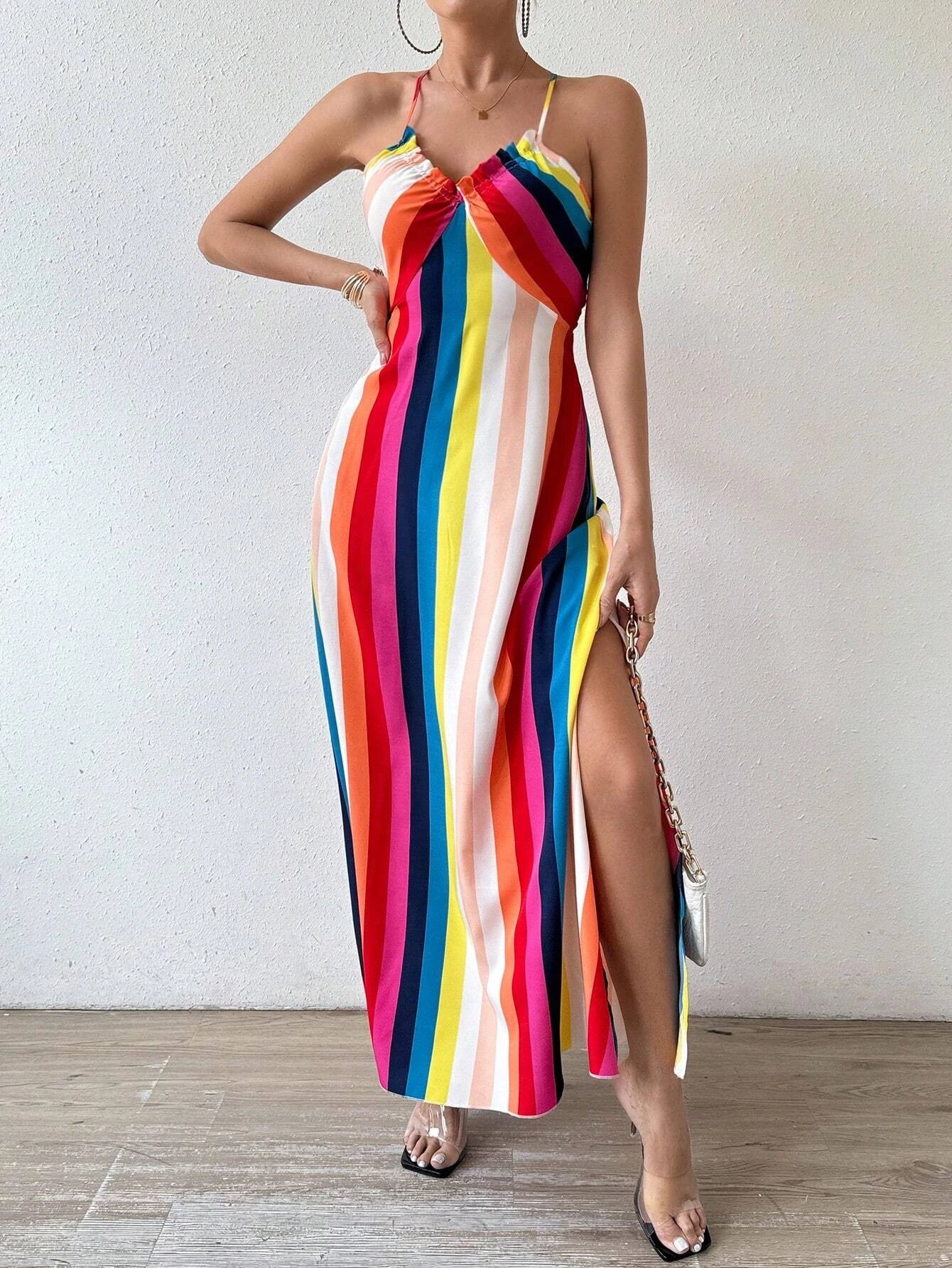 Woman wearing a colorful striped dress with a white background