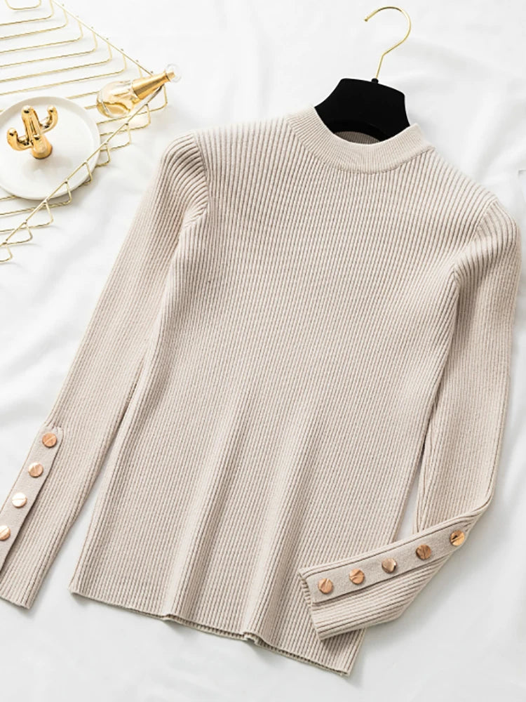 Beige ribbed sweater with button details on a white surface