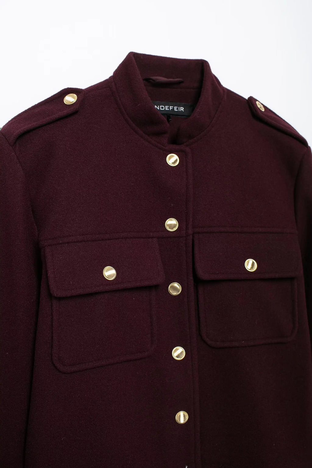 Maroon coat with gold buttons on a white background