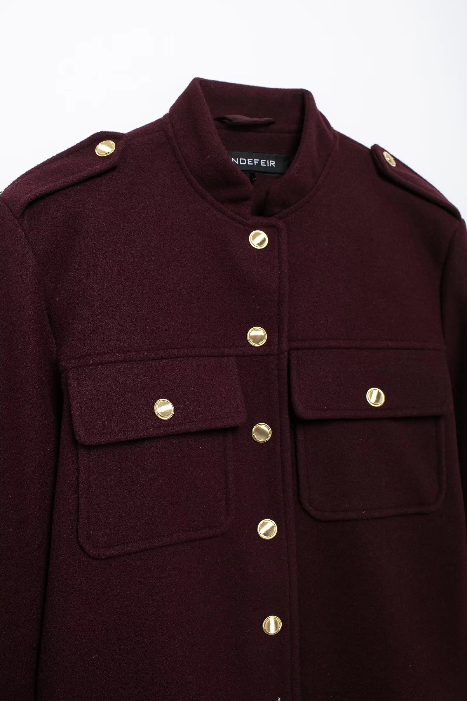 Maroon coat with gold buttons on a white background