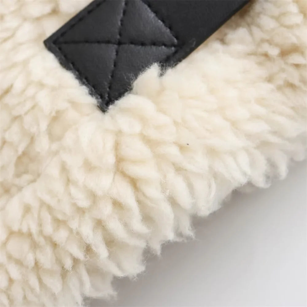 Close-up of a fluffy white rug with a black border on a light background