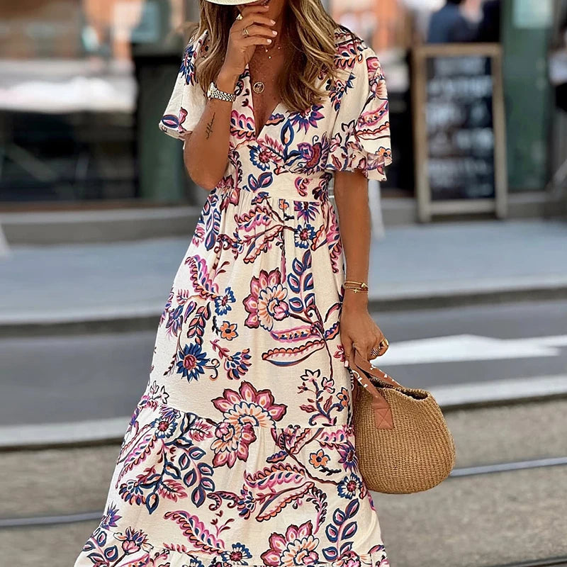 Woman wearing a floral dress with a blurred street background