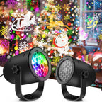 Two black LED projectors with colorful lights in front of a decorated Christmas tree.