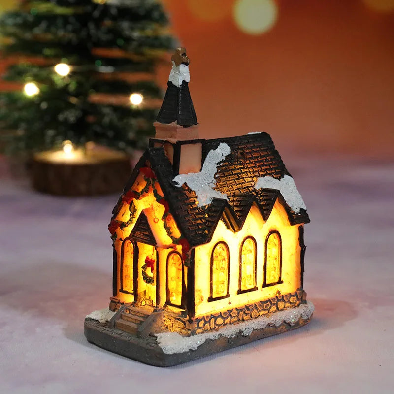 Decorative Christmas church ornament with warm glow in front of a blurred Christmas tree.