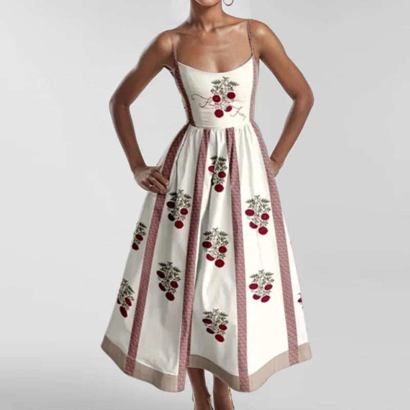 White dress with red cherry pattern on a plain background