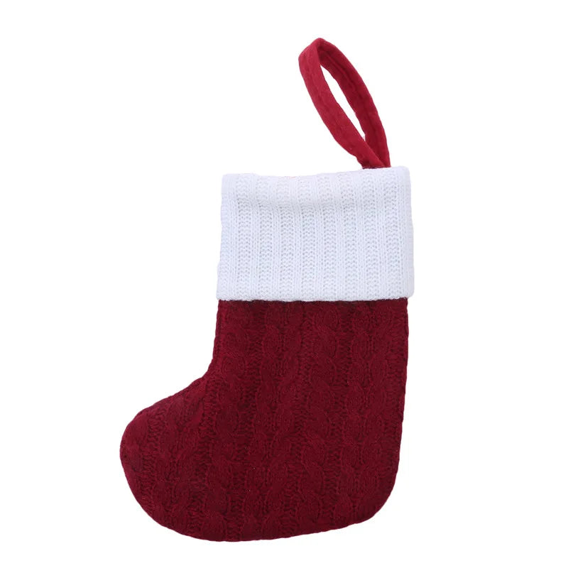 Red knitted Christmas stocking with white cuff on a white background