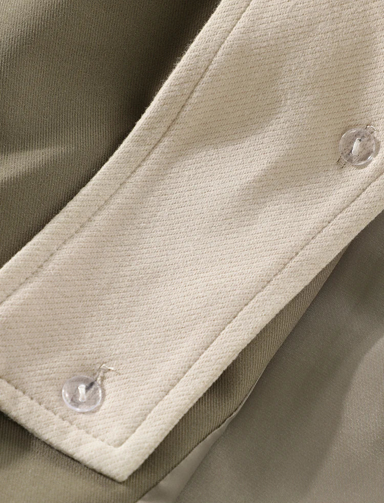 Close-up of a beige fabric with buttons on a brown background