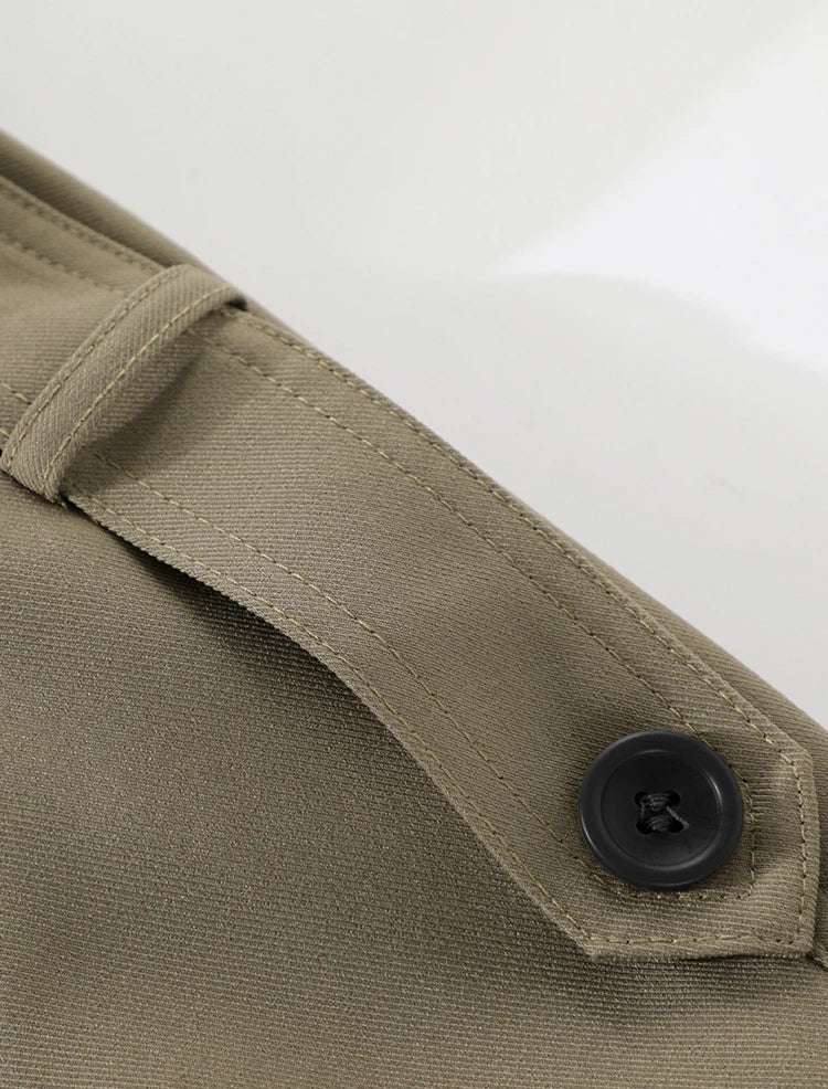 Close-up of a button on a beige fabric with a white background