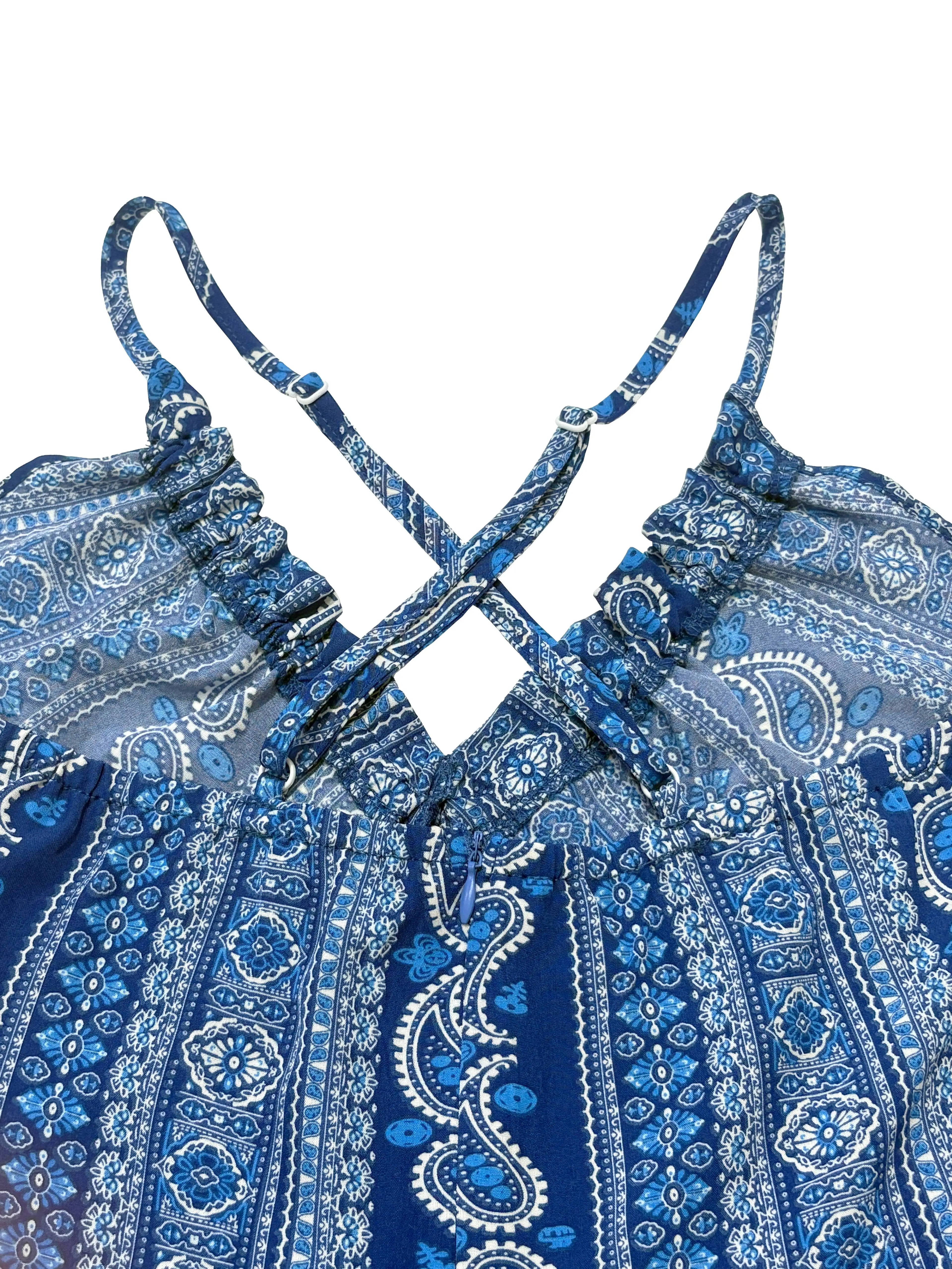 Blue and white patterned dress with criss-cross straps on a white background