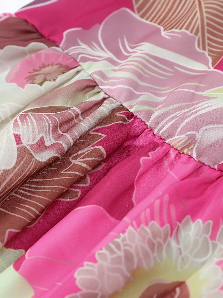 Close-up of a floral quilt with pink, white, and brown colors.