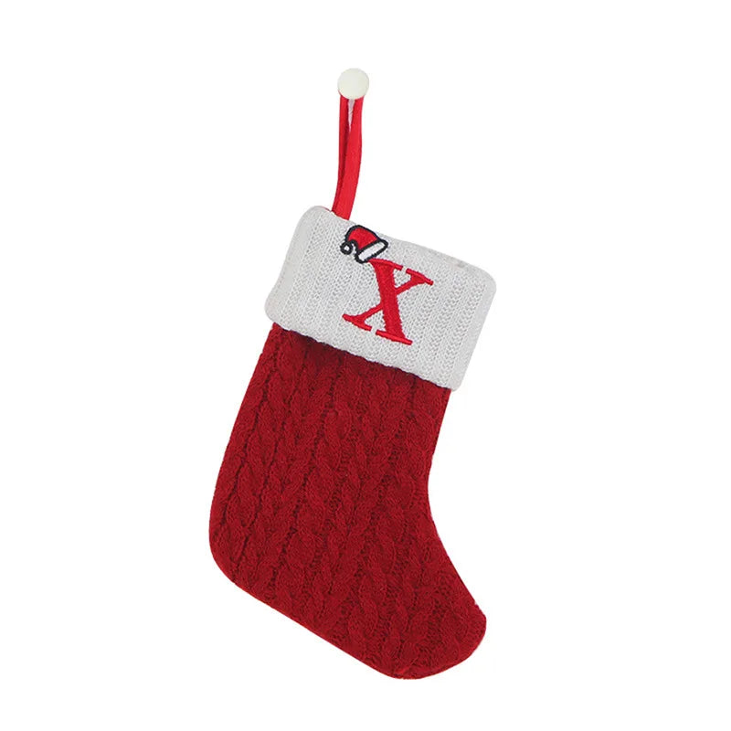 Red Christmas stocking with white cuff featuring a red 'X' on a white background