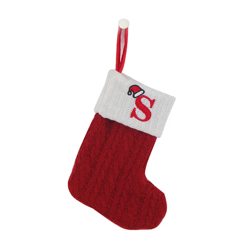 Red Christmas stocking with white cuff featuring a red letter 'S' on a white background