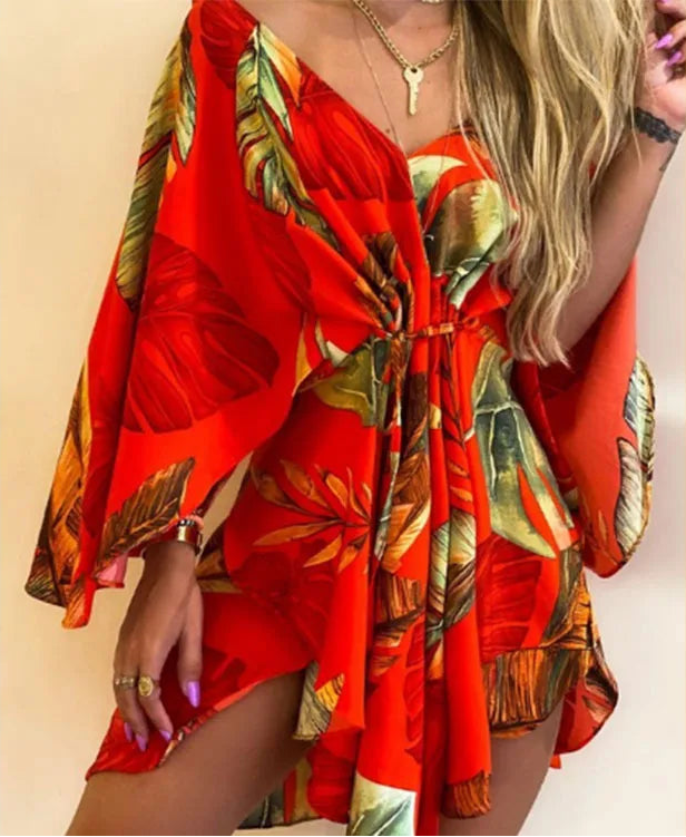 Red dress with tropical leaf pattern worn by a person on a beige background