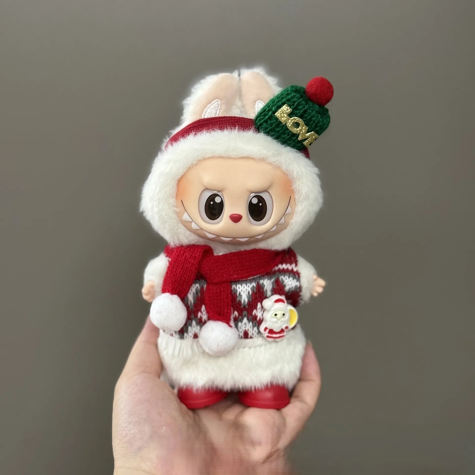 Toy figure in a festive outfit with a gray background