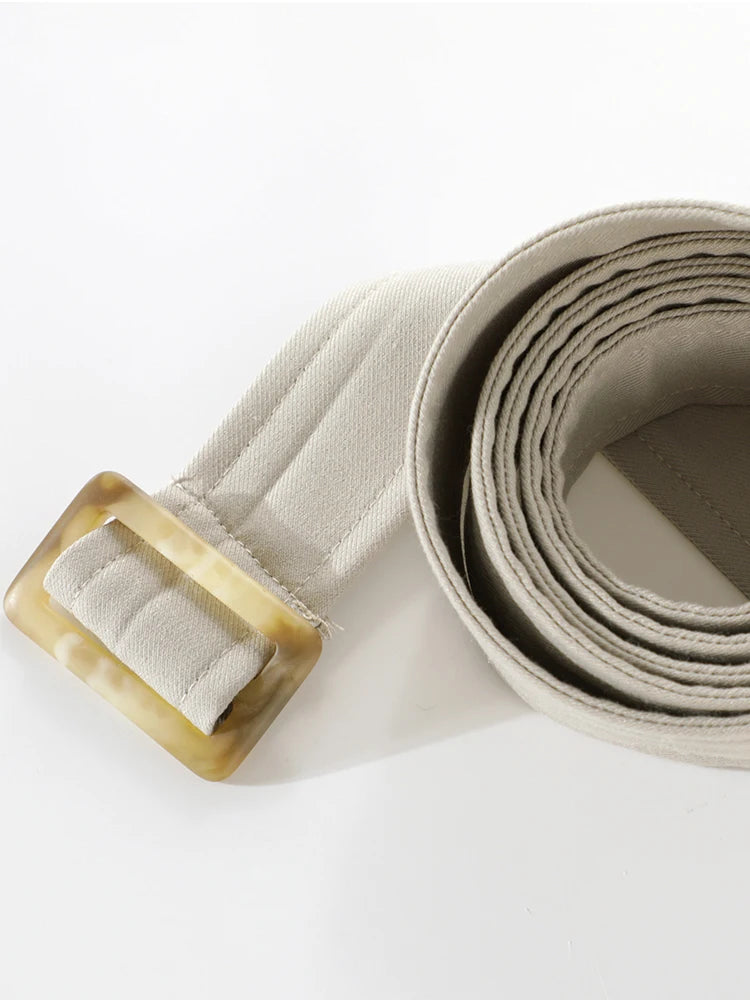 Beige belt with a gold buckle on a white background