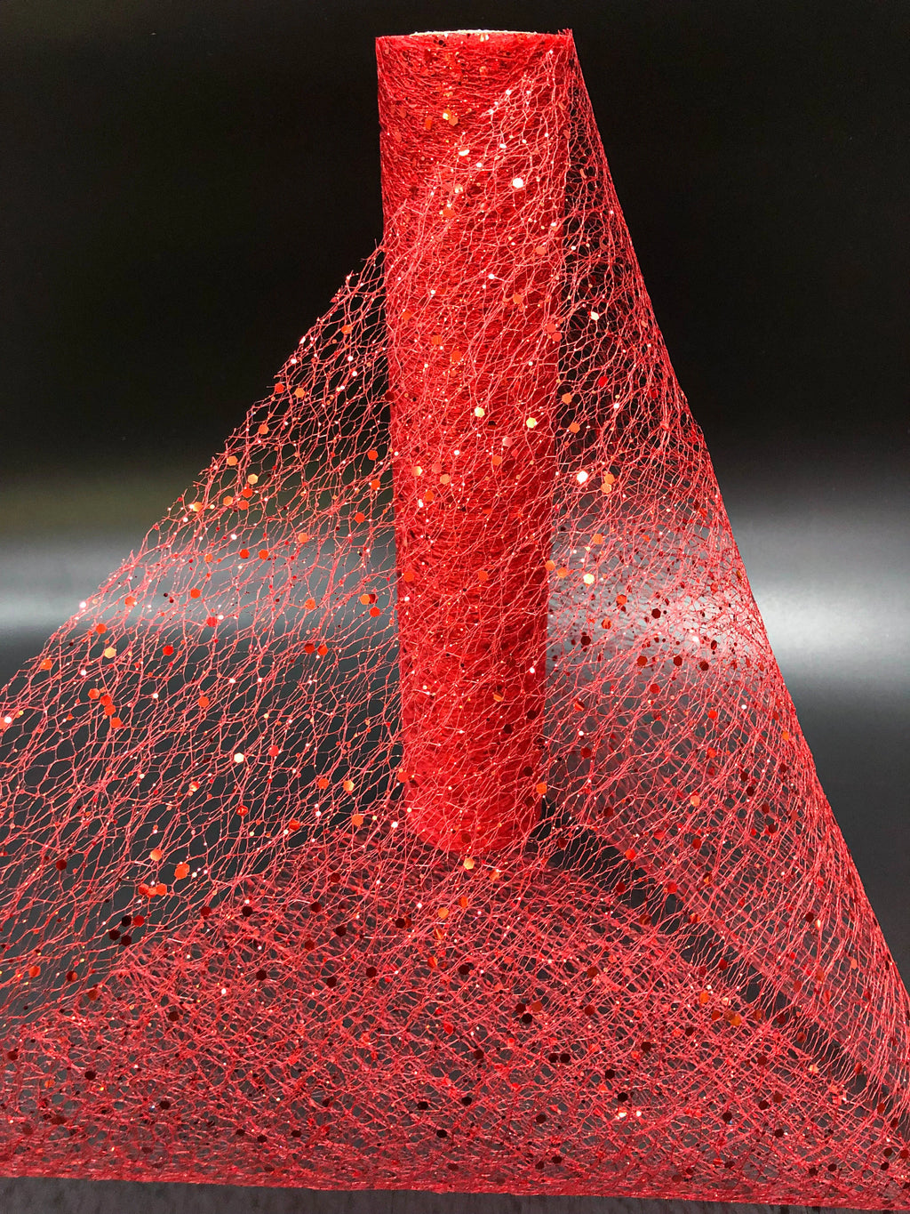 Red glittery mesh fabric on a black background