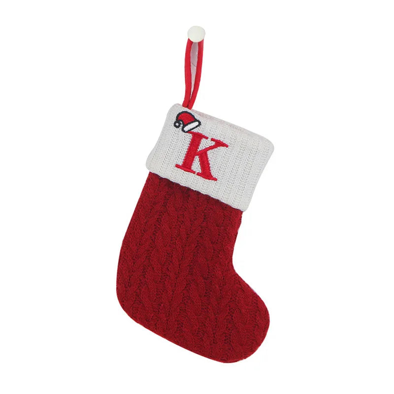 Red knitted Christmas stocking with white cuff featuring a red 'K' on a white background