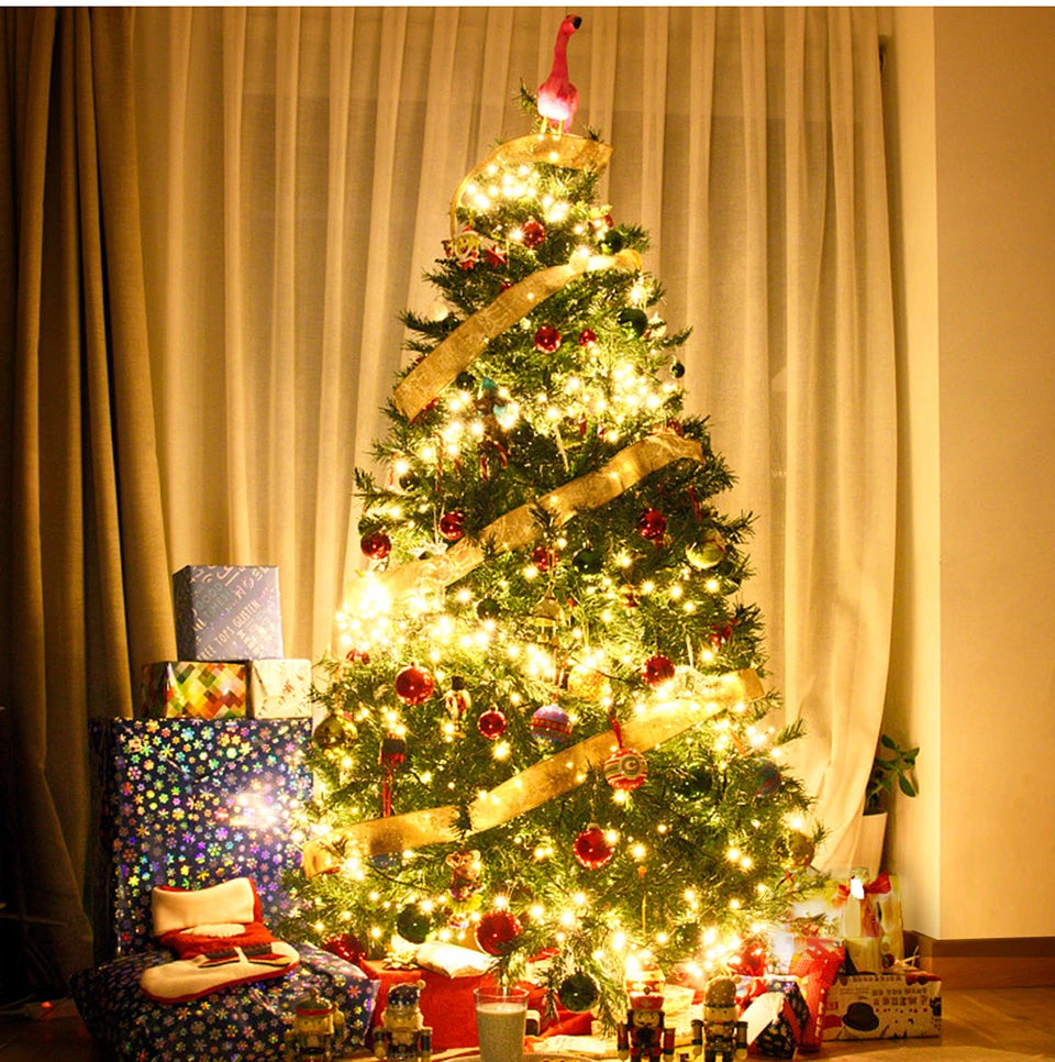 Decorated Christmas tree with lights and ornaments in a room with curtains.
