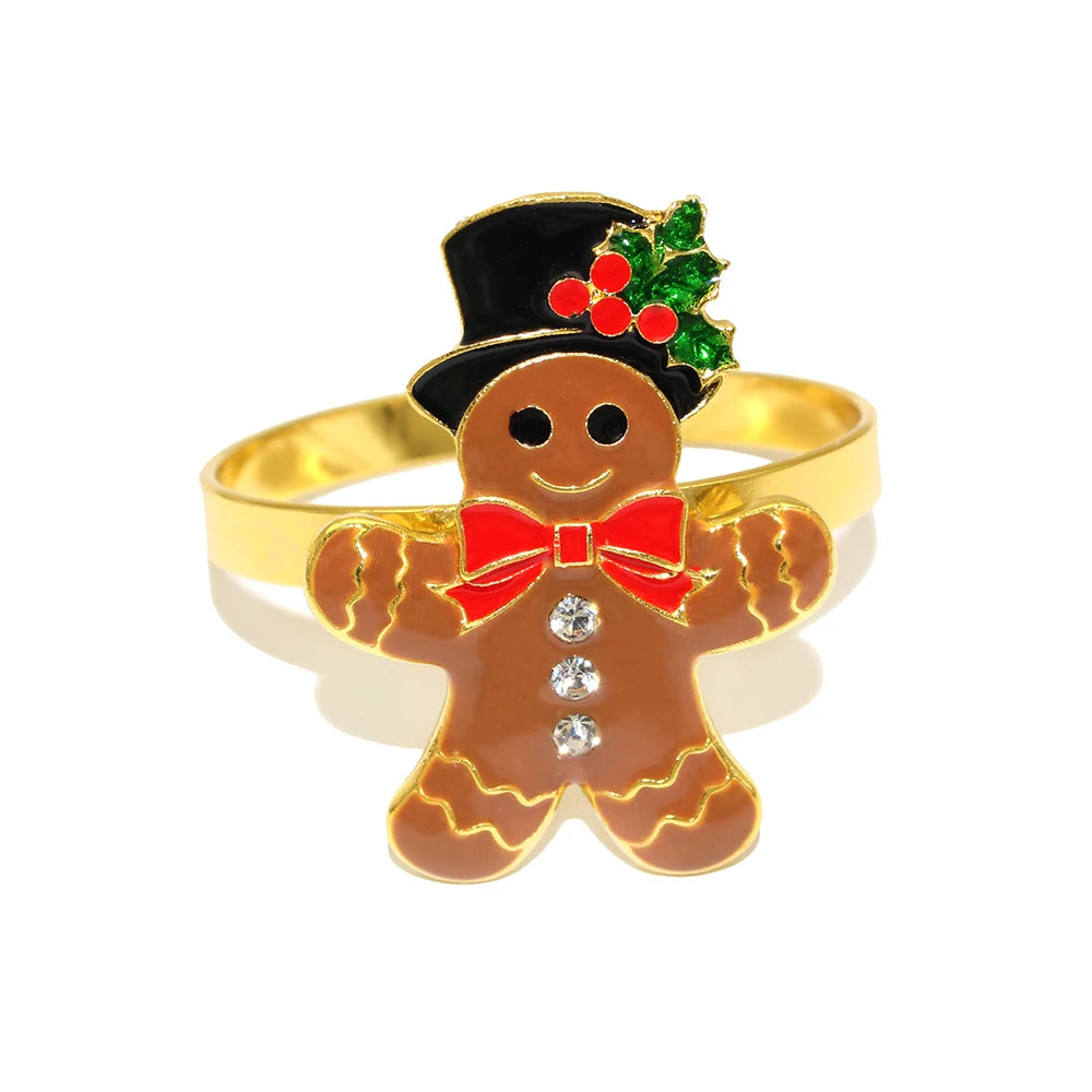 Gingerbread man ring with gold band, red bow tie, and top hat with holly on a white background