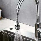 Chrome kitchen faucet with a flexible sprayer head on a sink.