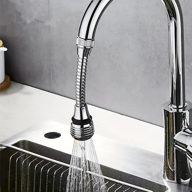 Chrome kitchen faucet with a flexible sprayer head on a sink.