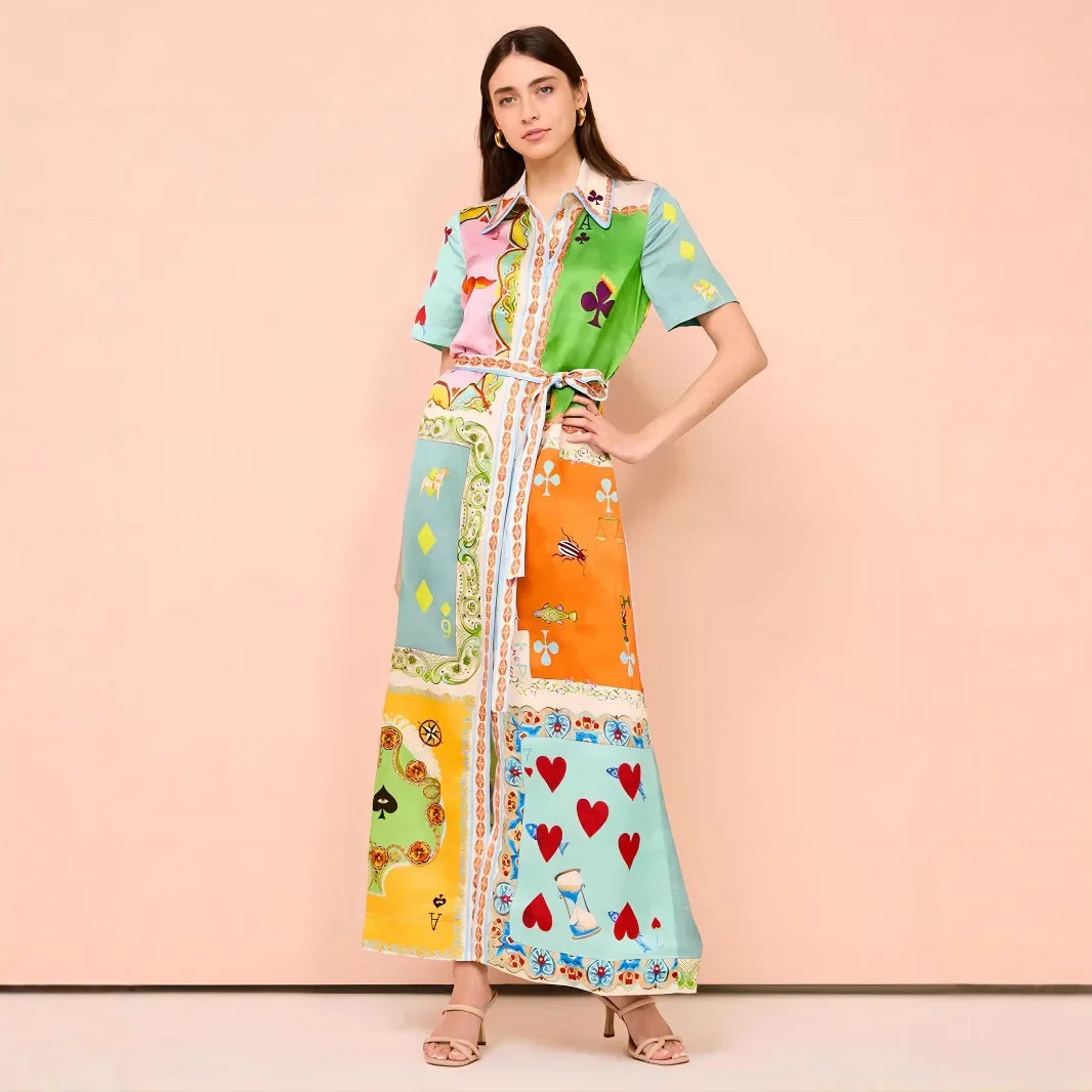 Woman wearing a colorful patterned dress on a pink background