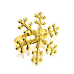 Gold snowflake-shaped ring on a white background