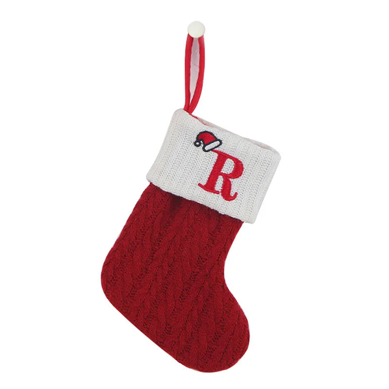 Red Christmas stocking with white cuff featuring a red 'R' on a white background