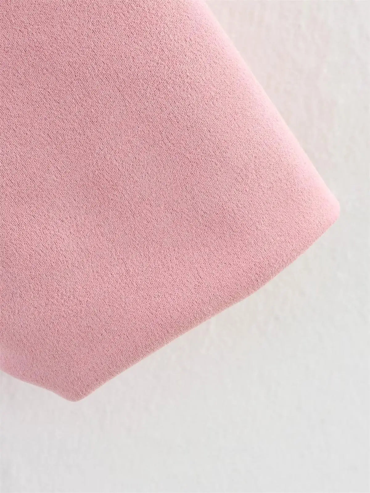 Close-up of a pink textured fabric on a light gray background