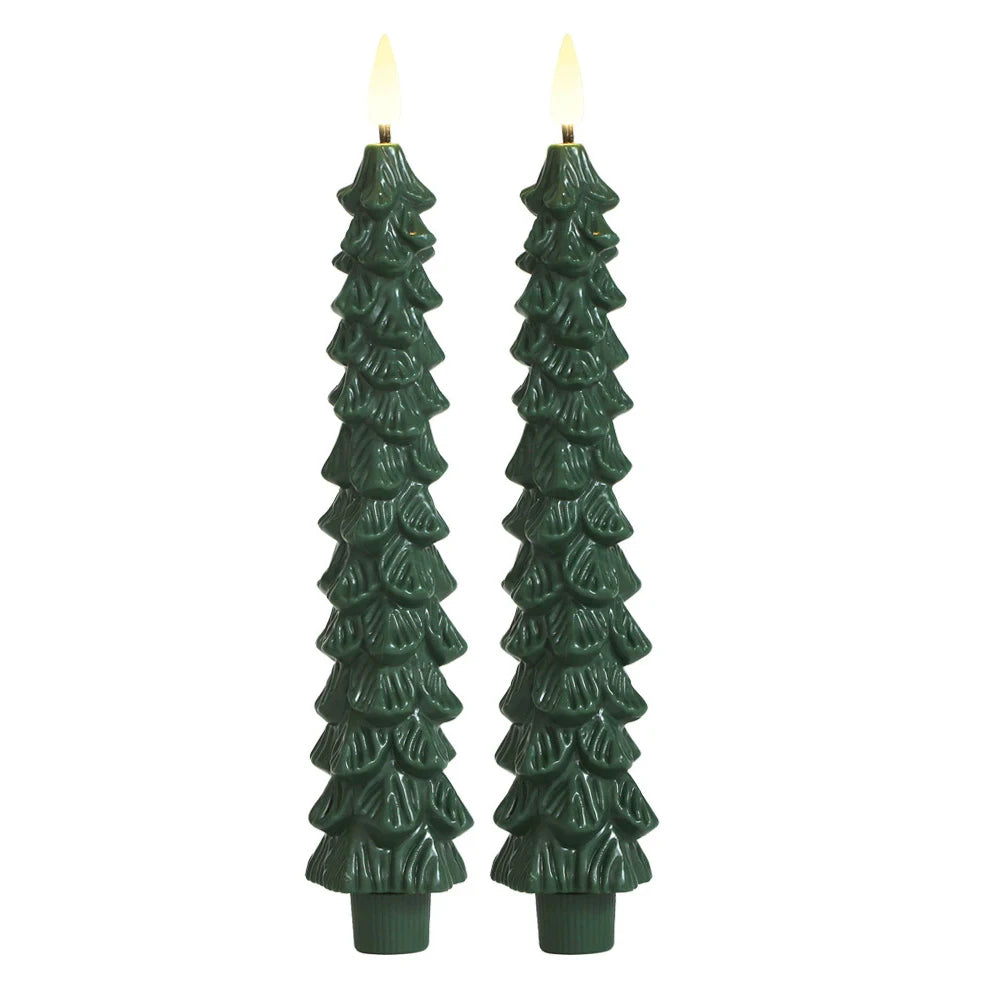 Two green tree-shaped candles on a white background