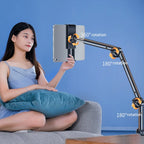 Woman sitting on a couch using a tablet holder with 360-degree rotation capabilities against a blue background.