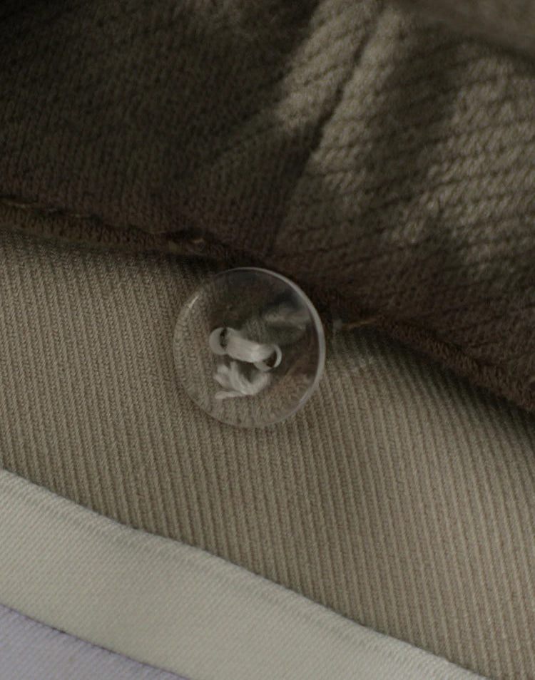 Close-up of a button on a textured fabric surface