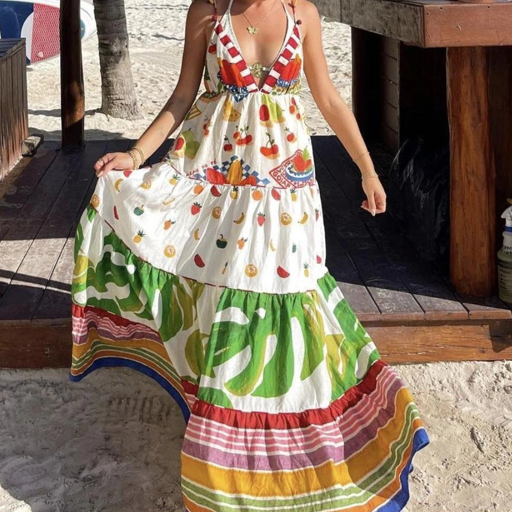Woman wearing a colorful, patterned dress on a beach setting