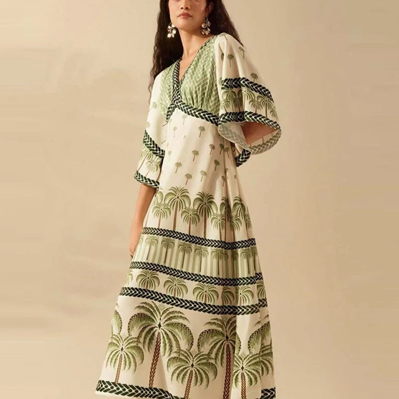 Woman wearing a patterned dress with palm tree design on a beige background