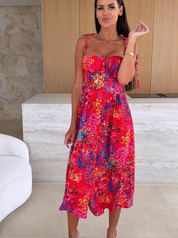 Woman wearing a colorful floral dress in an indoor setting