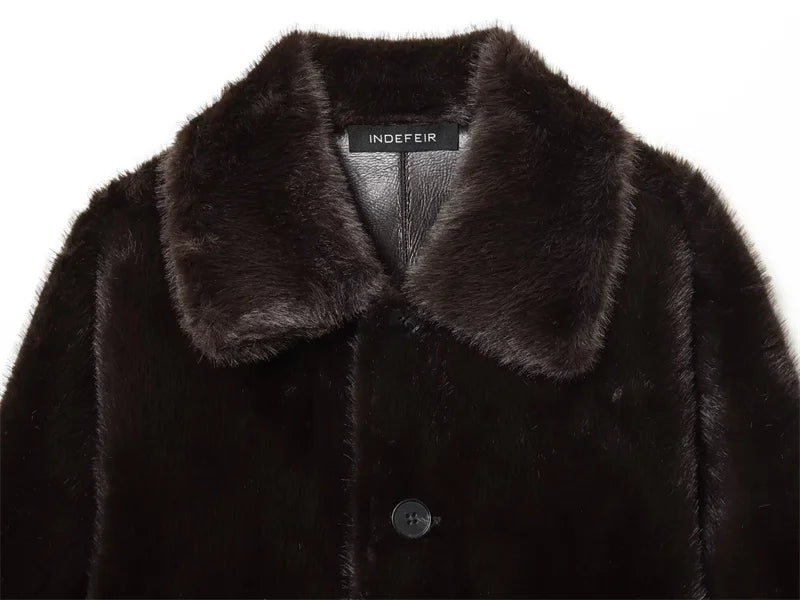 Dark brown faux fur coat with collar and 'INDEFEUR' label on a white background