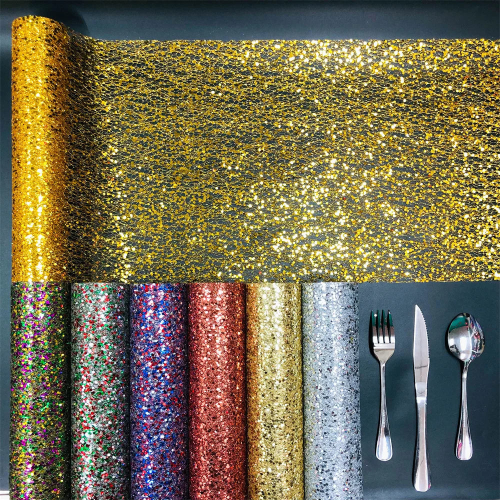 Roll of gold glitter paper with other color options and silverware on a dark background