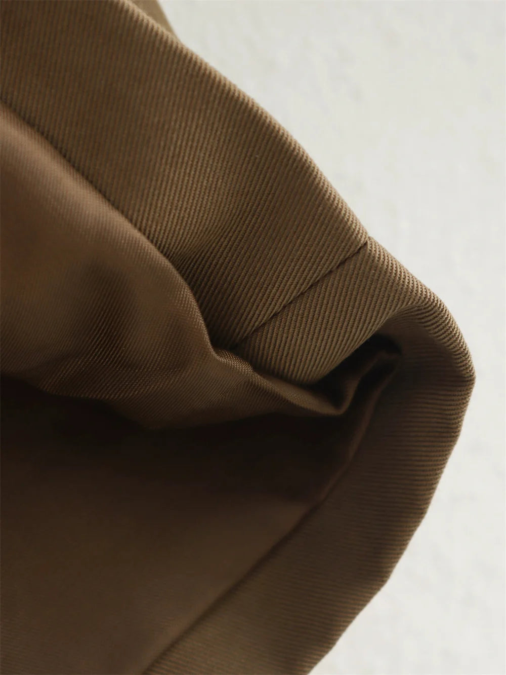Close-up of brown fabric texture on a light background