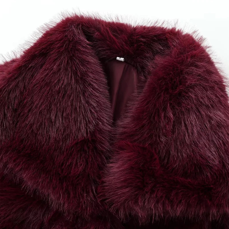 Close-up of a burgundy fur garment with a white background
