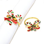 Two festive bow-shaped rings with red, green, and gold colors on a white background.